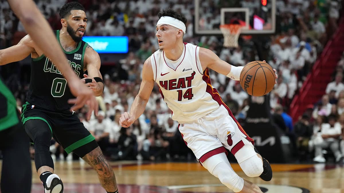 Miami Heat guard Tyler Herro (14) drives to the basket as Boston Celtics forward Jayson Tatum (0) defends in the first half during game three of the first round for the 2024 NBA playoffs at Kaseya Center.