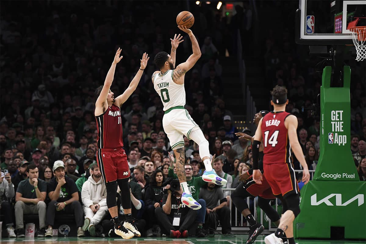 Boston Celtics forward Jayson Tatum (0) shoots the ball while Miami Heat guard Jaime Jaquez Jr. (11) defends during the first half in game one of the first round for the 2024 NBA playoffs at TD Garden.