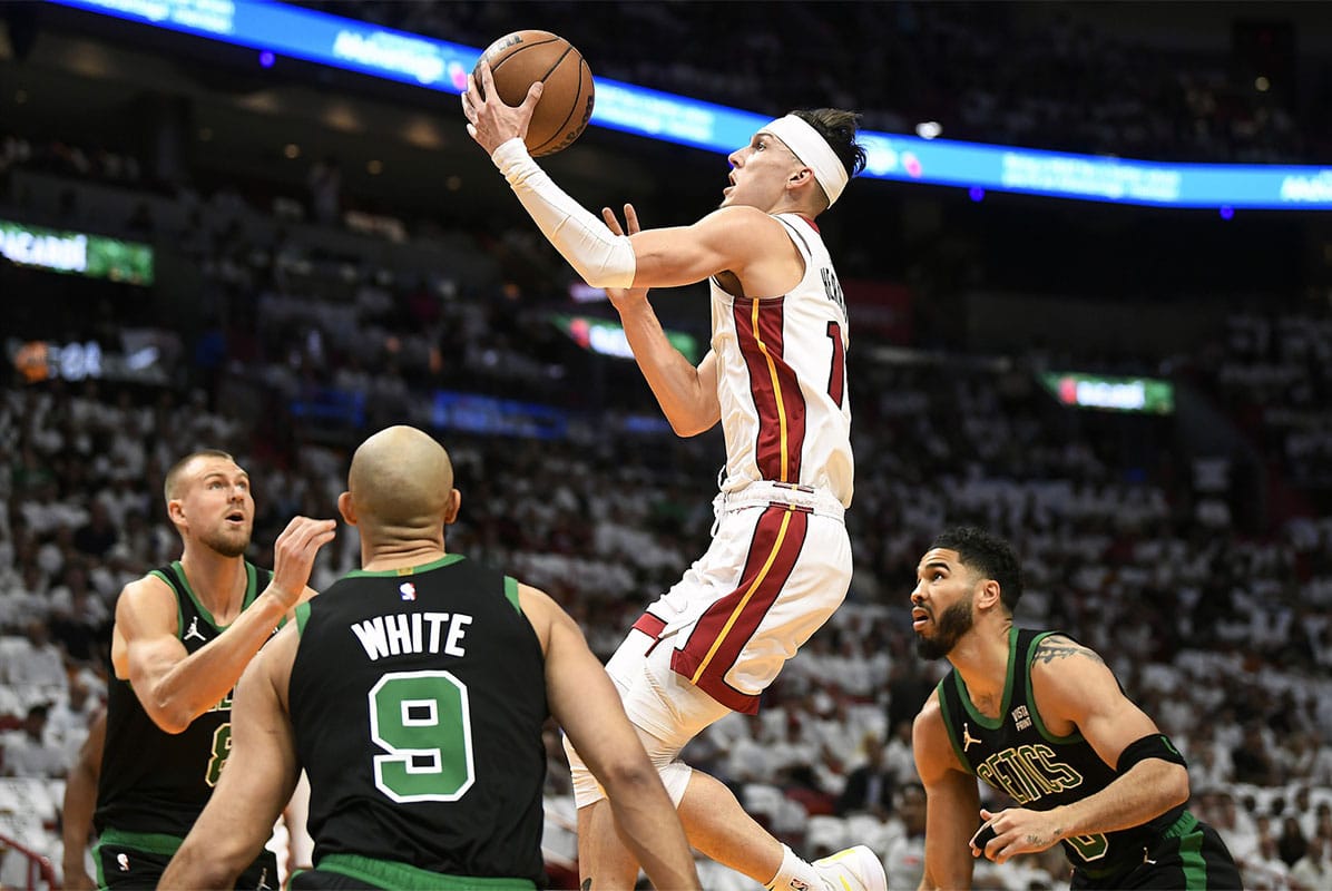 Miami Heat guard Tyler Herro (14) drives to the basket surrounded by Boston Celtics players during the first quarter of game four of the first round for the 2024 NBA playoffs at Kaseya Center.
