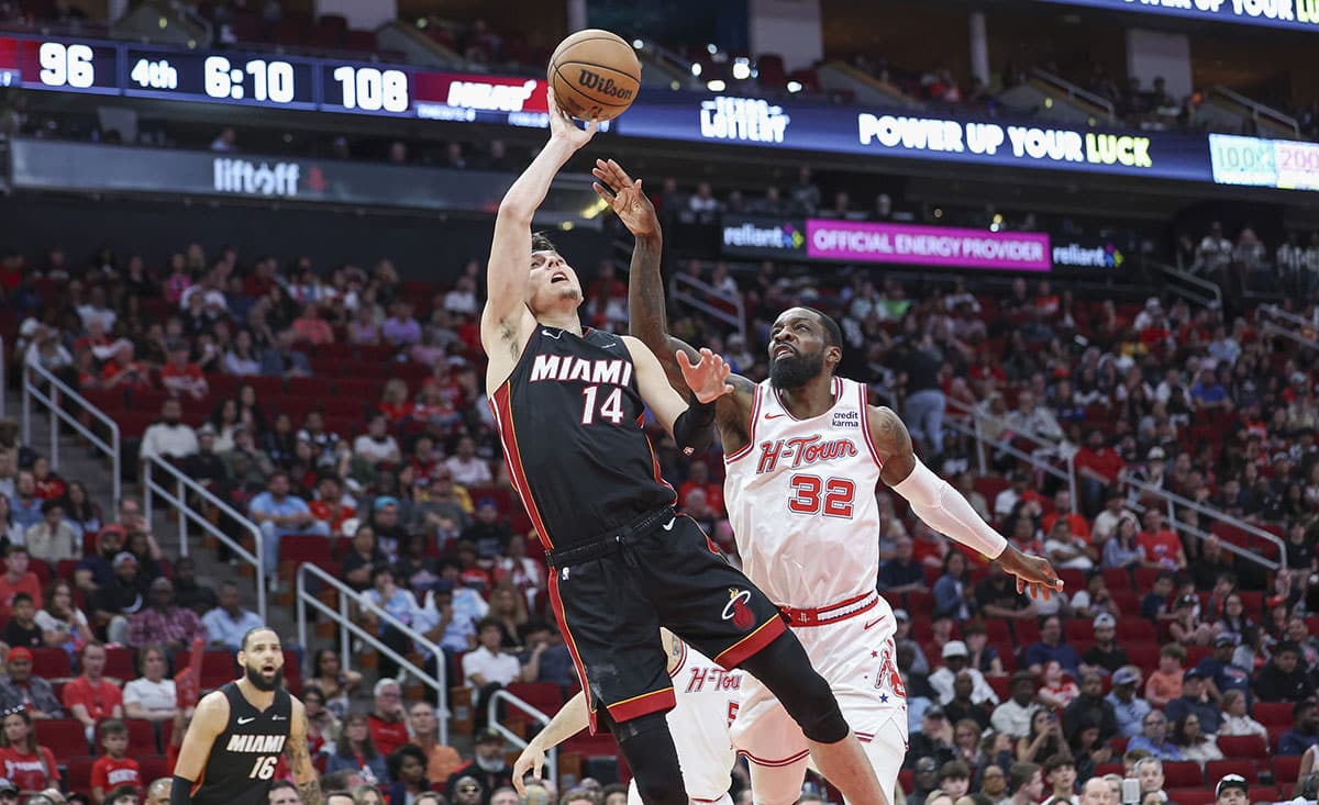 Miami Heat guard Tyler Herro (14) shoots the ball as Houston Rockets forward Jeff Green (32) defends during the fourth quarter at Toyota Center.