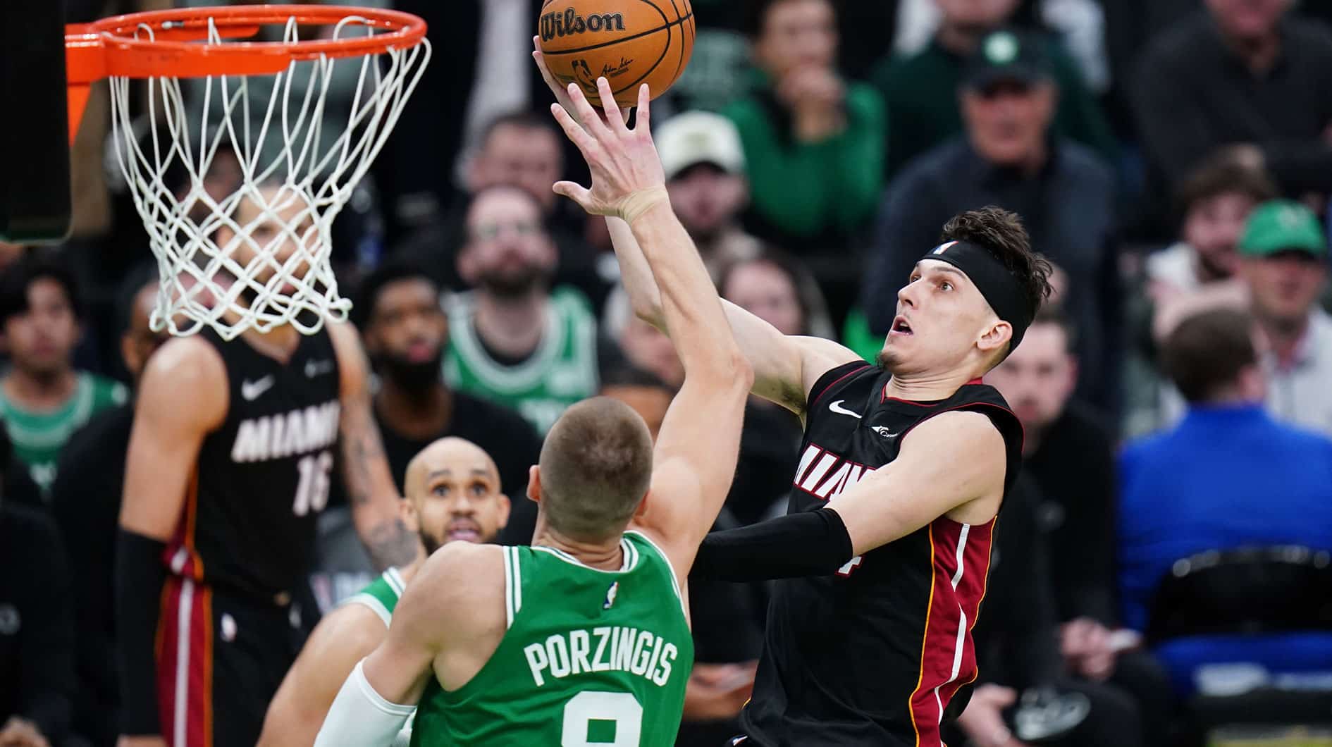 Miami Heat guard Tyler Herro (14) drives to the basket against Boston Celtics center Kristaps Porzingis (8) in the second half during game two of the first round for the 2024 NBA playoffs at TD Garden.