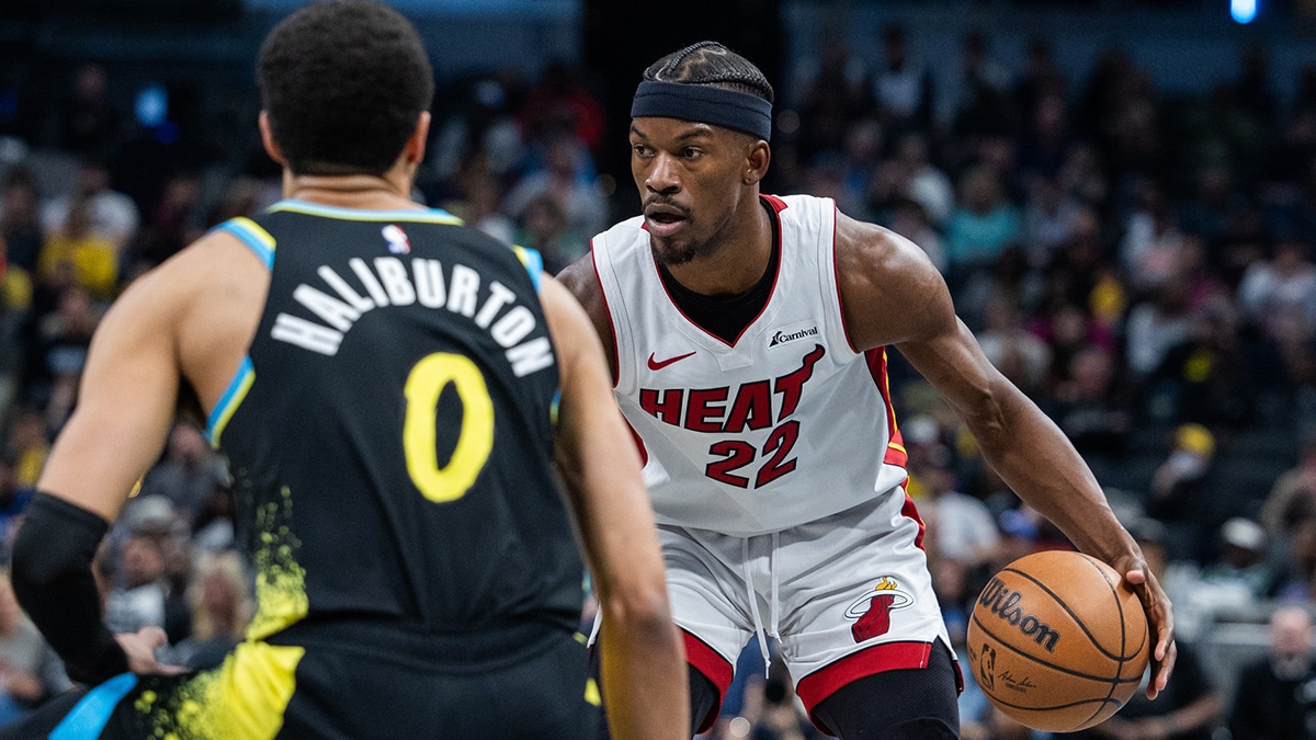 Miami Heat forward Jimmy Butler (22) dribbles the ball while Indiana Pacers guard Tyrese Haliburton (0) defends in the second half at Gainbridge Fieldhouse.