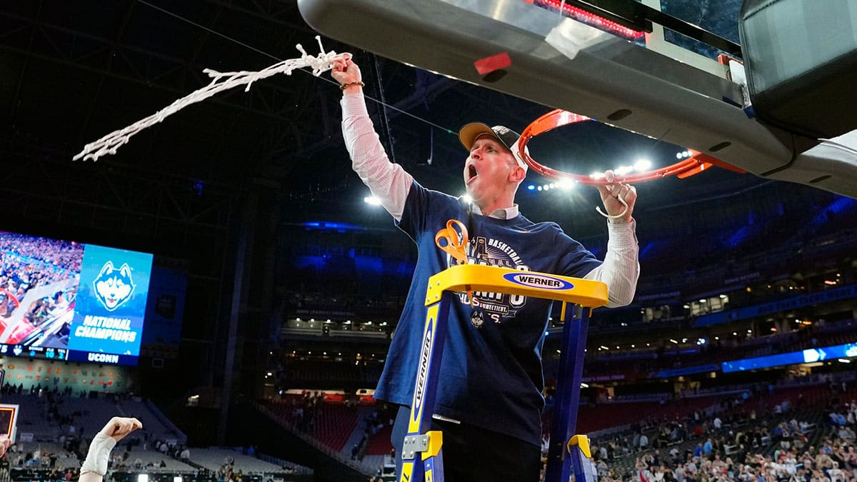 Connecticut Huskies head coach Dan Hurley cuts down the cut after defeating the Purdue Boilermakers in the national championship game of the Final Four of the 2024 NCAA Tournament at State Farm Stadium.
