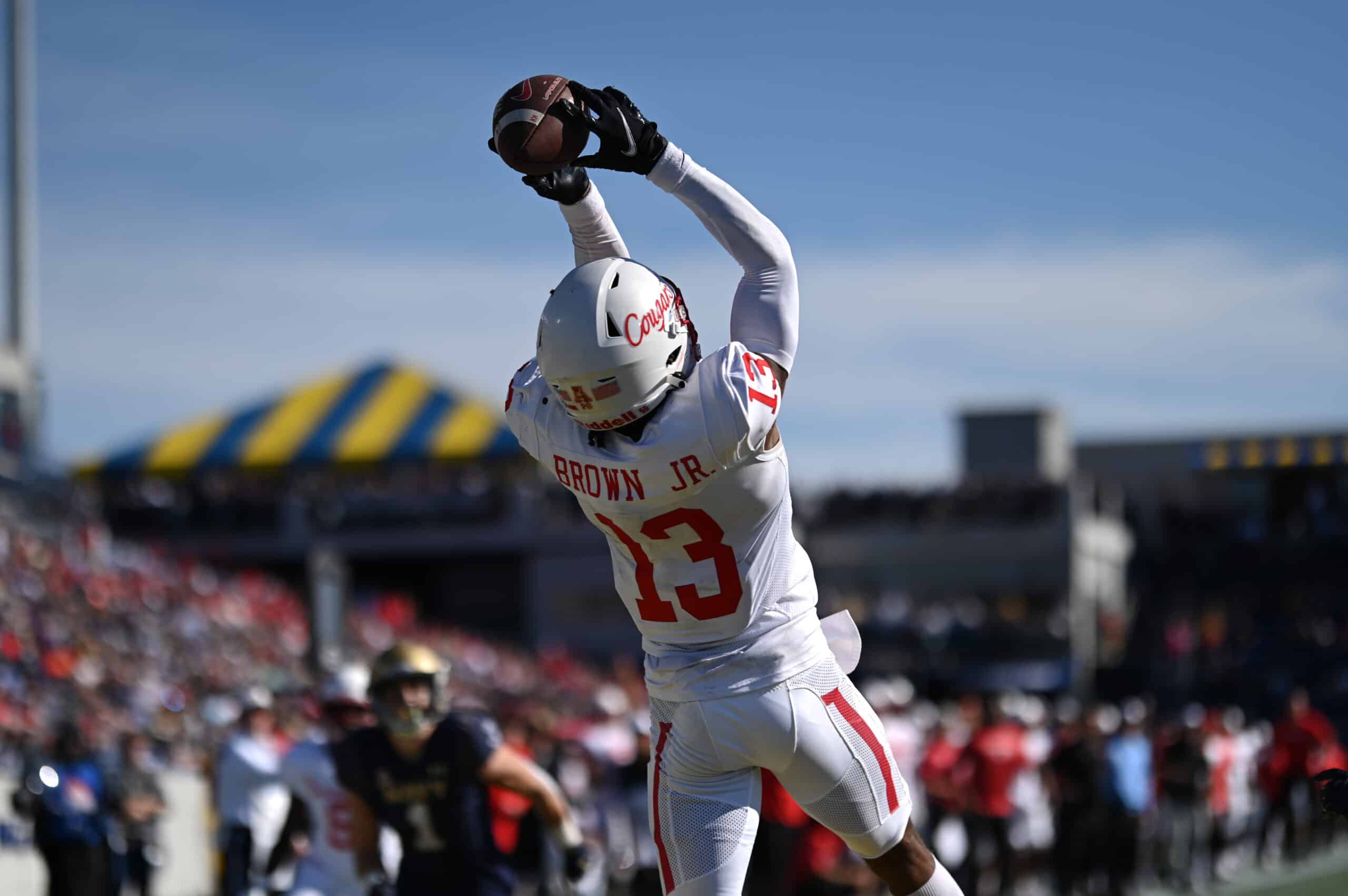 Oct 22, 2022; Annapolis, Maryland, USA; Houston Cougars wide receiver Sam Brown (13) leaps to catch a touchdown against the Navy Midshipmen at Navy-Marine Corps Memorial Stadium. Mandatory Credit: 