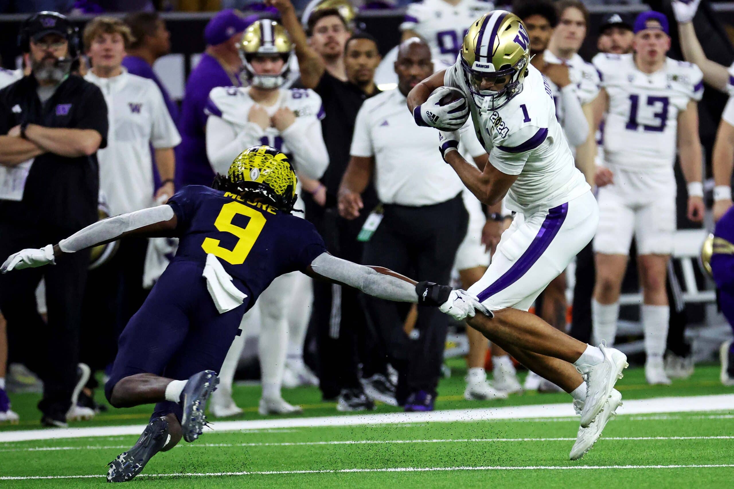 Jan 8, 2024; Houston, TX, USA; Washington Huskies wide receiver Rome Odunze (1) runs the ball after a catch against Michigan Wolverines defensive back Rod Moore (9) during the fourth quarter in the 2024 College Football Playoff national championship game at NRG Stadium. 