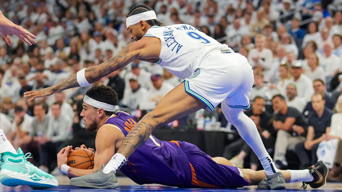 Phoenix Suns guard Devin Booker (1) calls a timeout against Minnesota Timberwolves guard Nickeil Alexander-Walker (9) in the second quarter during game two of the first round for the 2024 NBA playoffs at Target Center