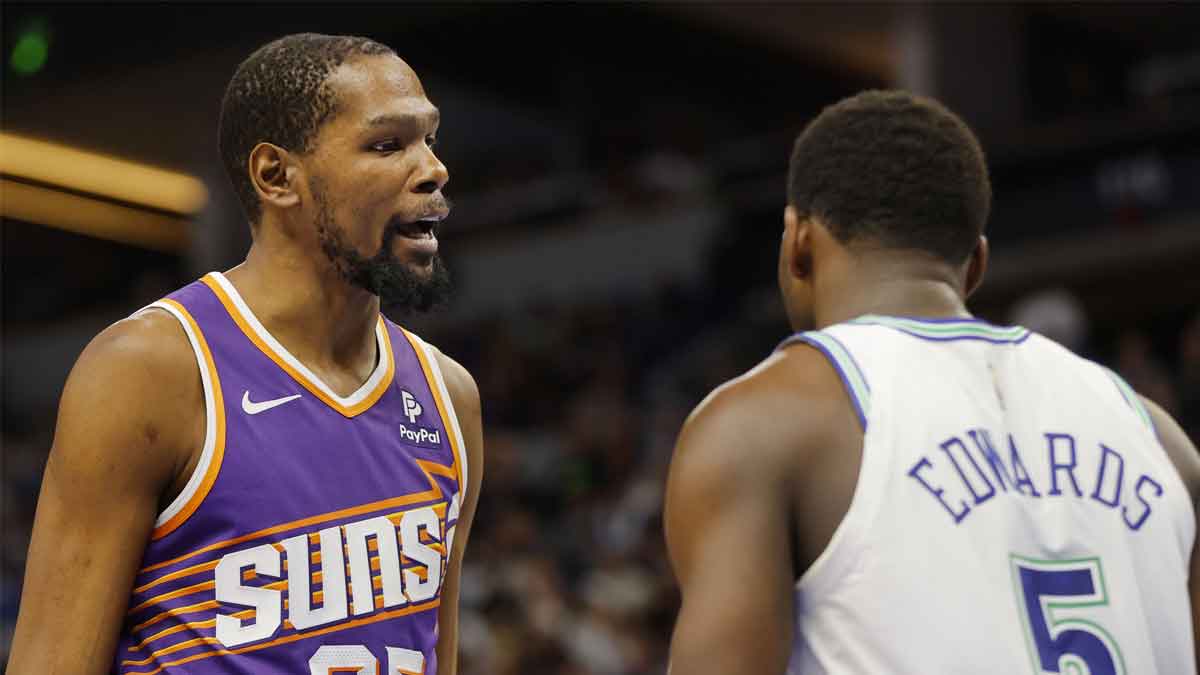 Phoenix Suns forward Kevin Durant (35) shares words with Minnesota Timberwolves guard Anthony Edwards (5) after fouling him in the third quarter at Target Center