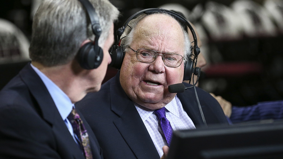 Verne Lundquist talking to his broadcast partner during his sportscasting career