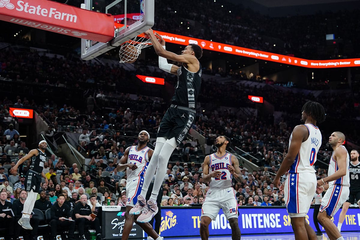 San Antonio Spurs center Victor Wembanyama (1) dunks in front of Philadelphia 76ers guards Jeff Dowtin Jr. (11) and Cameron Payne (22) in the first half at Frost Bank Center. 