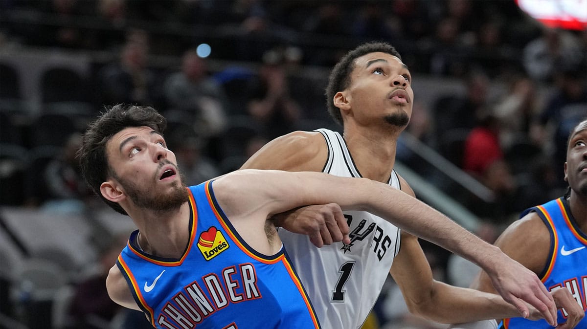 Oklahoma City Thunder forward Chet Holmgren (7) and San Antonio Spurs center Victor Wembanyama (1) battle for position in the first half at Frost Bank Center. 