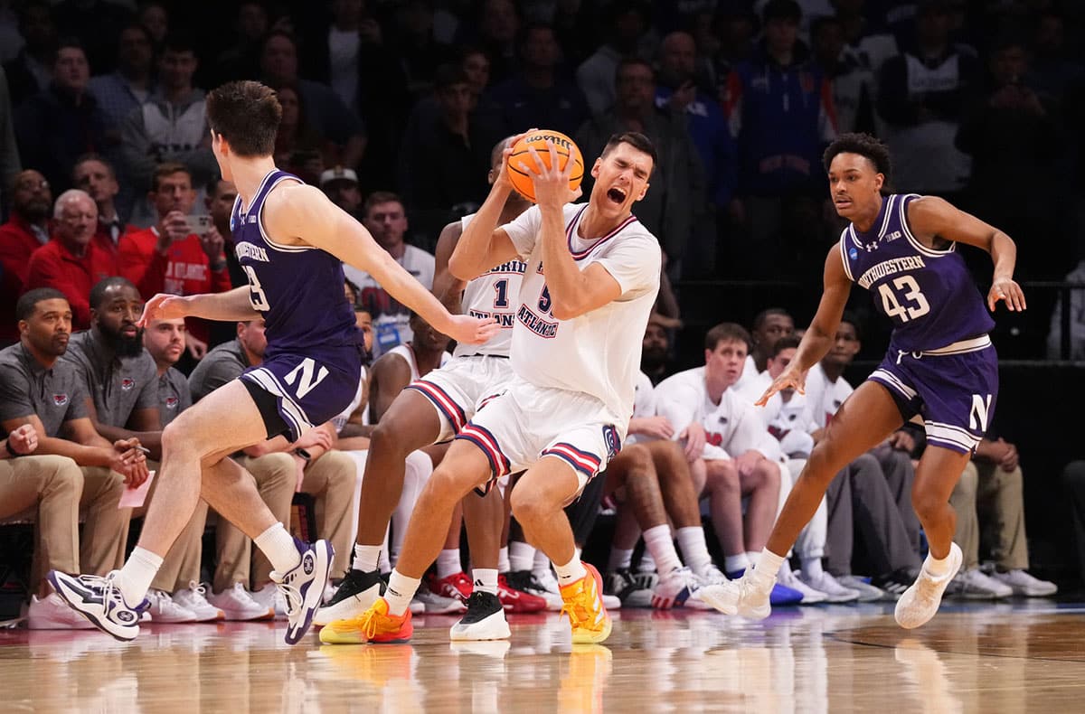 Florida Atlantic Owls center Vladislav Goldin (50) is fouled by Northwestern Wildcats guard Brooks Barnhizer (13) in the first round of the 2024 NCAA Tournament at the Barclays Center.