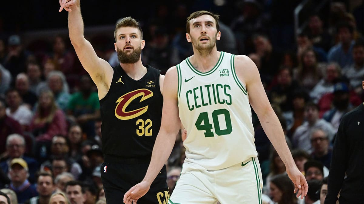 Cleveland Cavaliers forward Dean Wade (32) and Boston Celtics center Luke Kornet (40) watch as Wade makes a three point basket during the second half at Rocket Mortgage FieldHouse