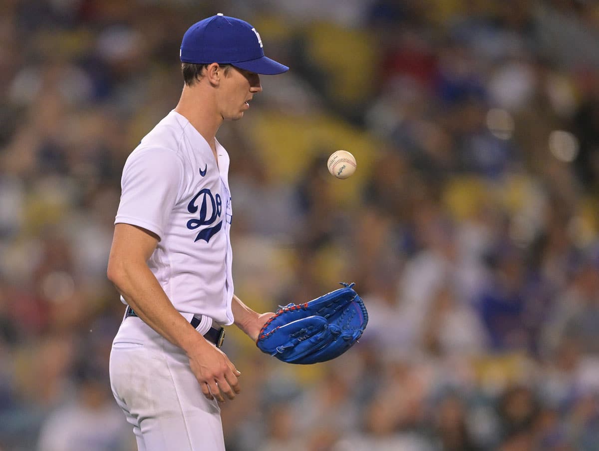 Los Angeles Dodgers starting pitcher Walker Buehler (21) tosses the ball at the mound after giving up a two run home run to Philadelphia Phillies designated hitter Kyle Schwarber (12) in the fourth inning at Dodger Stadium. 