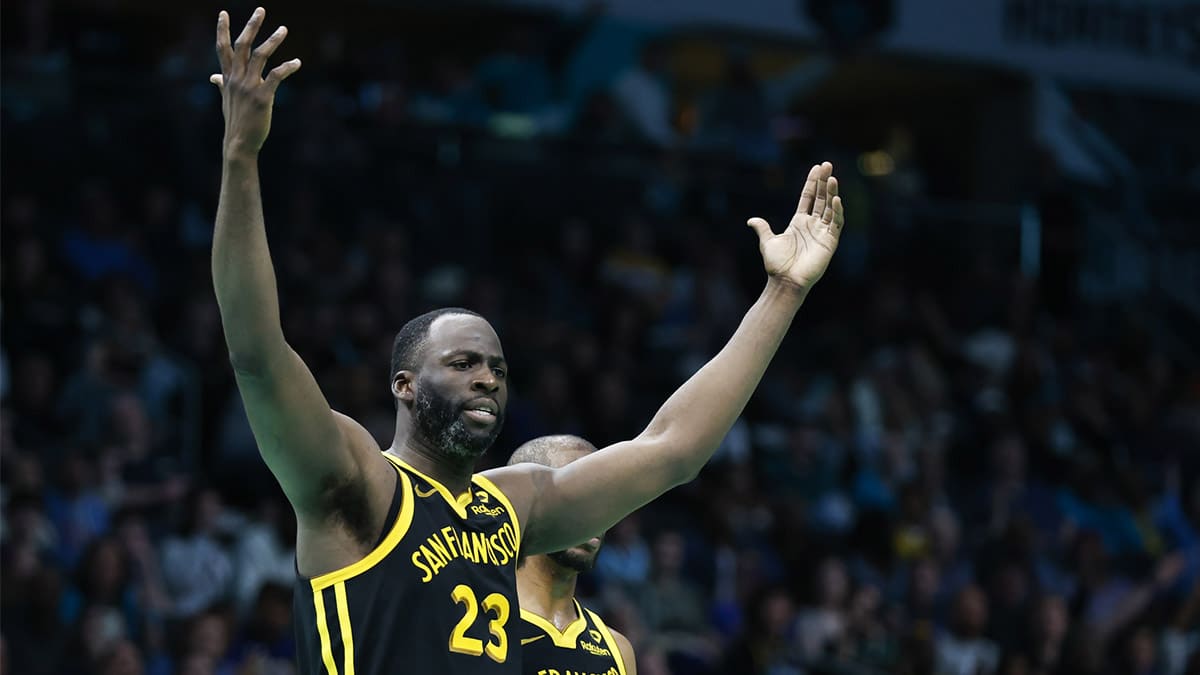 Golden State Warriors forward Draymond Green (23) reacts after being charged with a foul in the second half as the Warriors play against the Charlotte Hornets at Spectrum Center. 