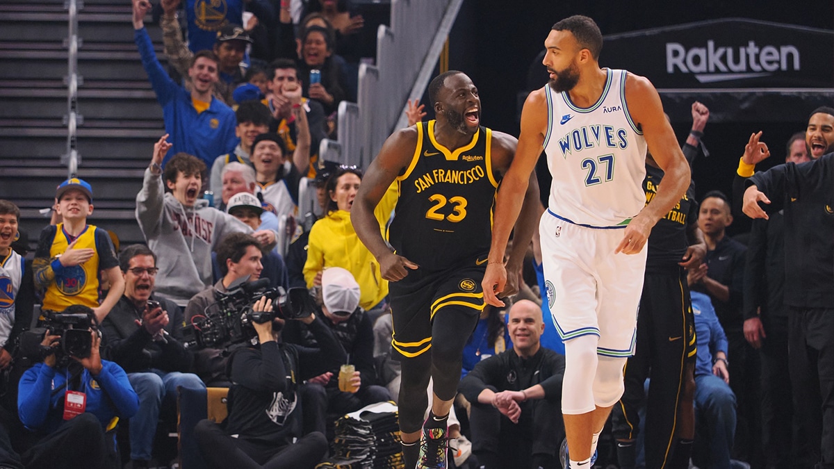 Golden State Warriors forward Draymond Green (23) celebrates behind Minnesota Timberwolves center Rudy Gobert (27) after scoring a three point basket during the first quarter at Chase Center