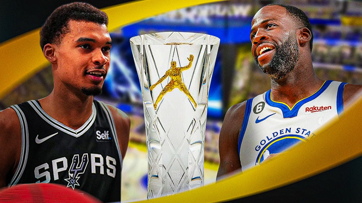 Spurs' Victor Wembanyama and Warriors' Draymond Green next to the Hakeem Olajuwon Trophy