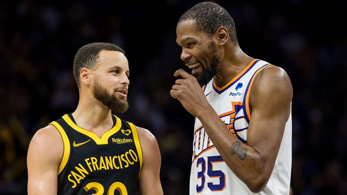 Golden State Warriors guard Stephen Curry (30) and Phoenix Suns forward Kevin Durant (35) talk during the second half at Chase Center