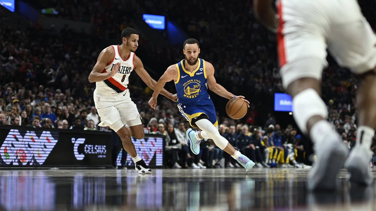 Golden State Warriors guard Stephen Curry (30) drives to the basket during the first half against Portland Trail Blazers forward Kris Murray (8) at Moda Center