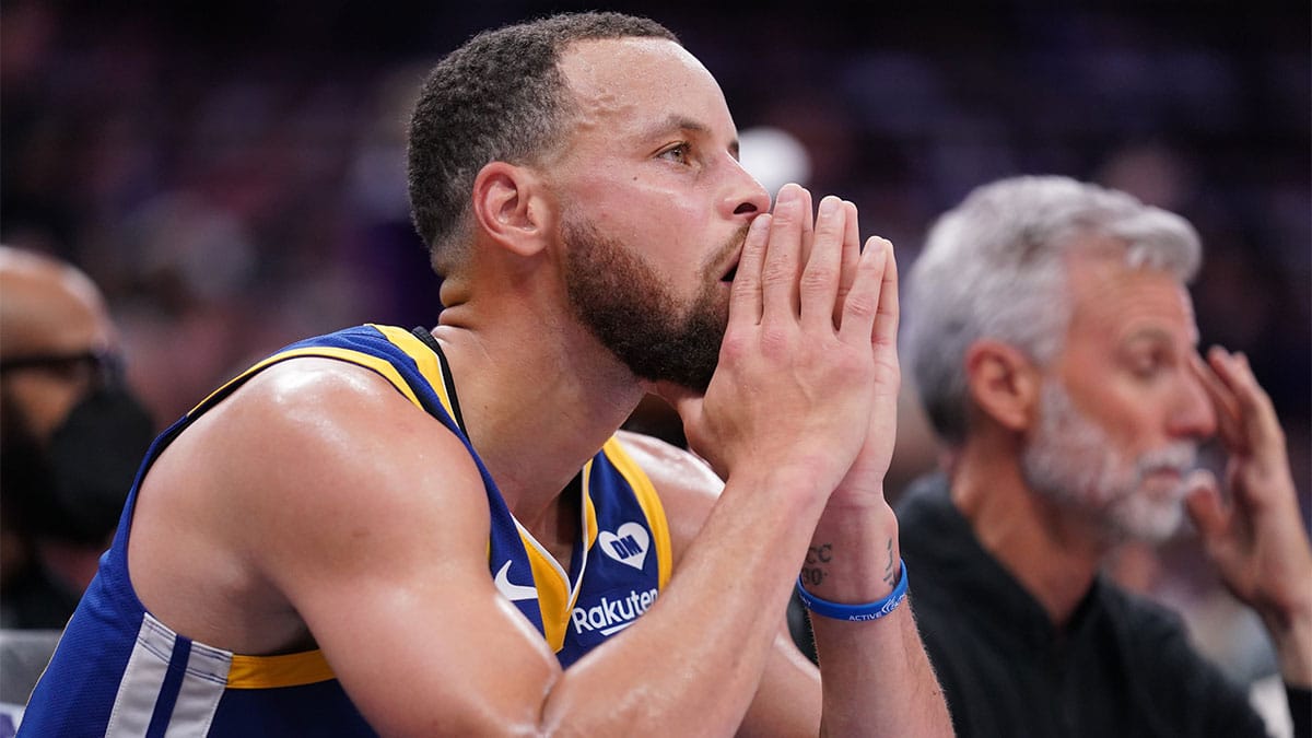 Golden State Warriors guard Stephen Curry (30) sits on the bench during action against the Sacramento Kings in the fourth quarter during a play-in game of the 2024 NBA playoffs at the Golden 1 Center