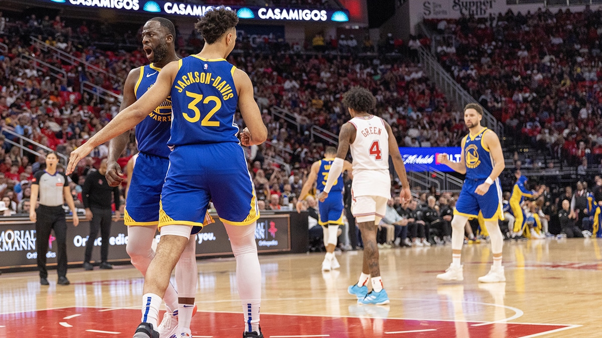 Golden State Warriors forward Andrew Wiggins (22) celebrates with forward Trayce Jackson-Davis (32) after a basket against the Houston Rockets in the second quarter at Toyota Center