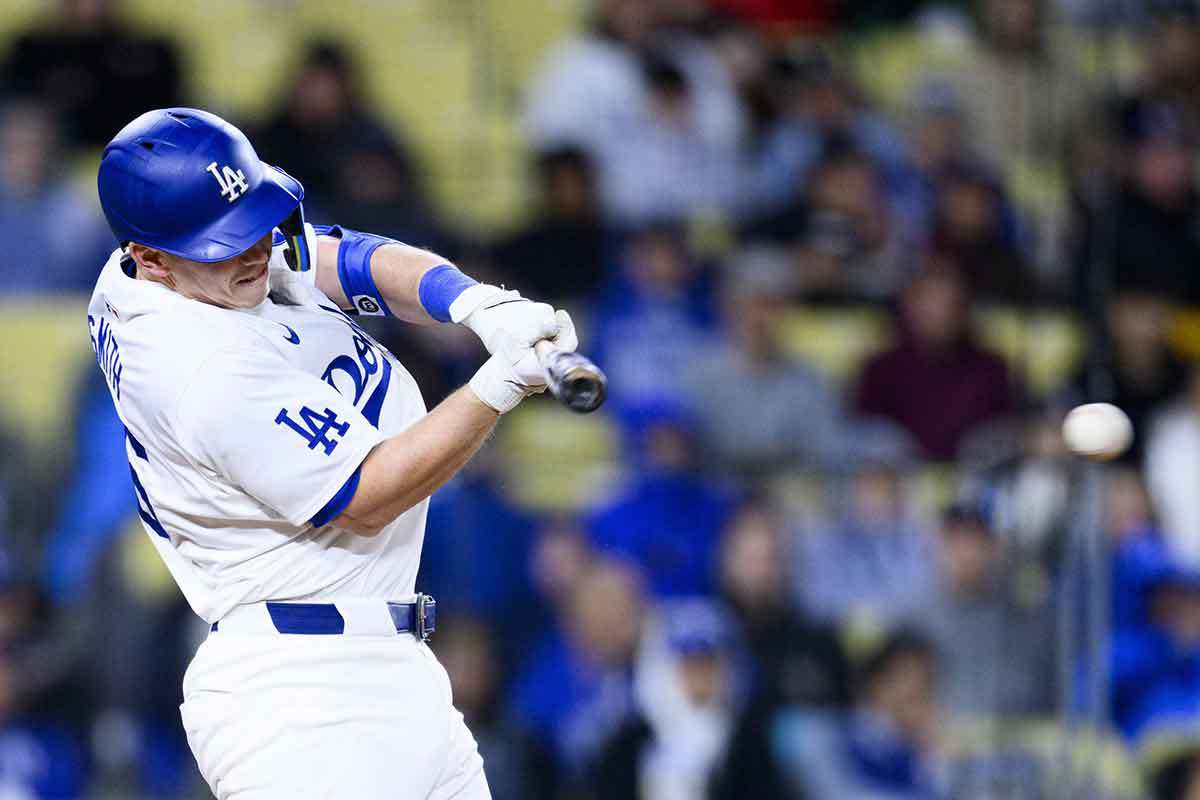 Los Angeles Dodgers catcher Will Smith (16) hits an RBI single during the fifth inning against the St. Louis Cardinals at Dodger Stadium. 