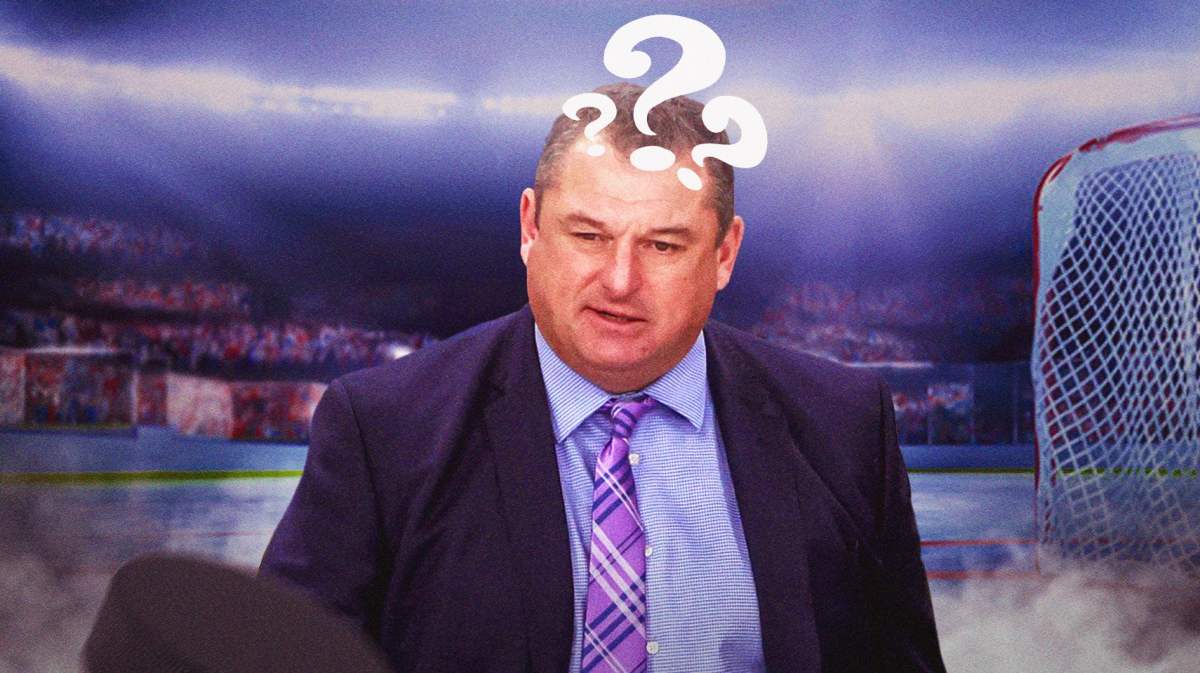 DJ Smith with a question mark on his head, hockey rink in background