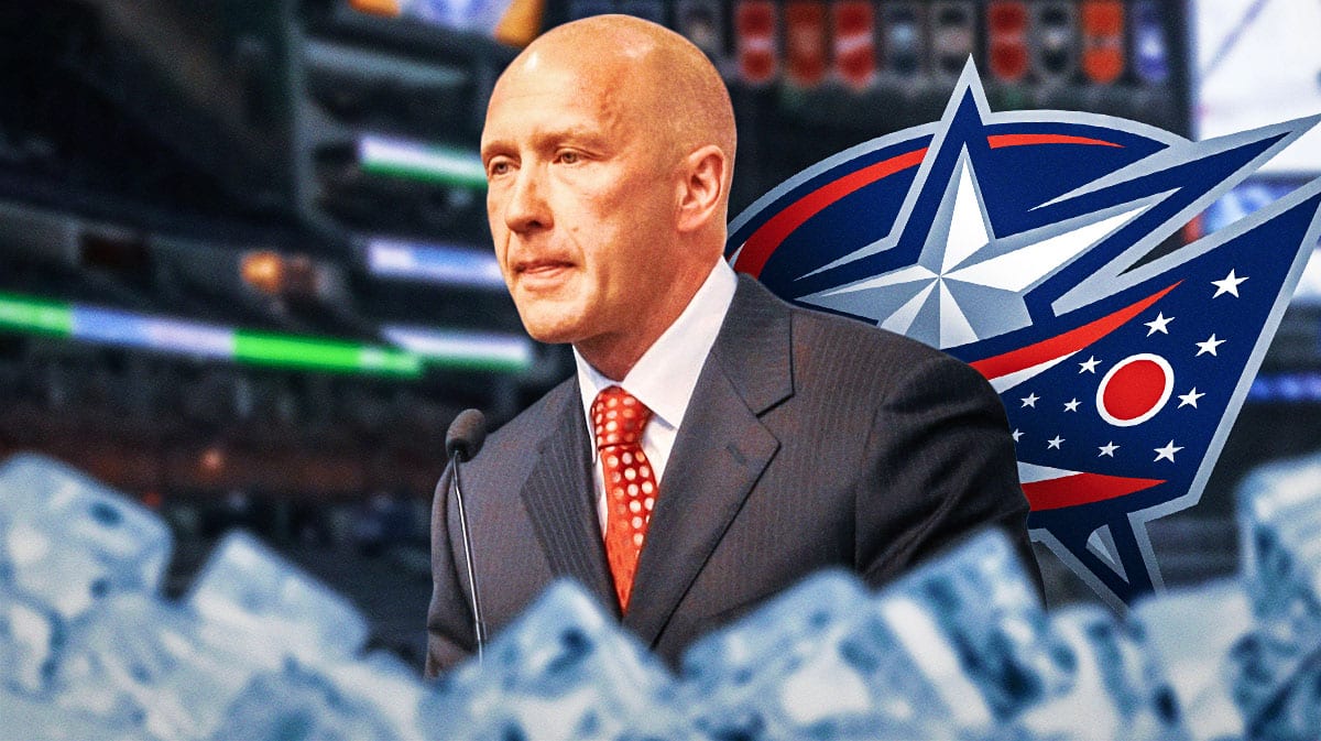 Jarmo Kekalainen looking serious, Blue Jackets logo in the background