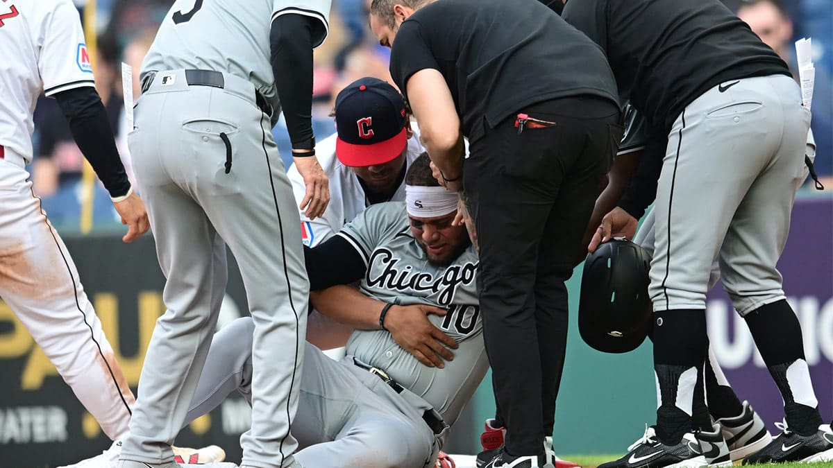 Chicago White Sox third baseman Yoan Moncada (10) is helped up after being injured during the second inning against the Cleveland Guardians at Progressive Field. 