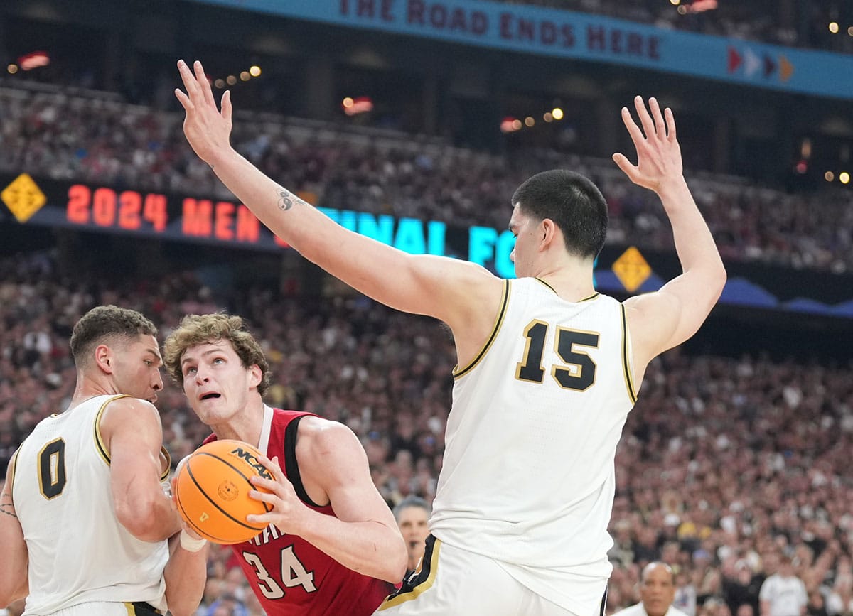 North Carolina State Wolfpack forward Ben Middlebrooks (34) shoots against Purdue Boilermakers forward Mason Gillis (0) and Purdue Boilermakers center Zach Edey (15) in the semifinals of the men's Final Four of the 2024 NCAA Tournament at State Farm Stadium