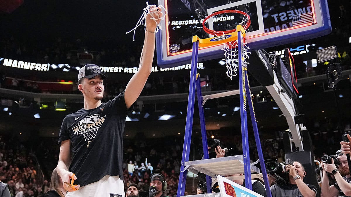 Purdue Boilermakers center Zach Edey (15) holds up a piece of the net Sunday, March 31, 2024, after defeating the Tennessee Volunteers for the midwest regional championship at the Little Caesars Arena in Detroit.