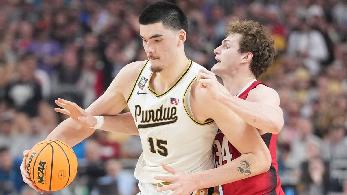 Purdue Boilermakers center Zach Edey (15) is defended by North Carolina State Wolfpack forward Ben Middlebrooks (34) in the semifinals of the men's Final Four of the 2024 NCAA Tournament at State Farm Stadium.