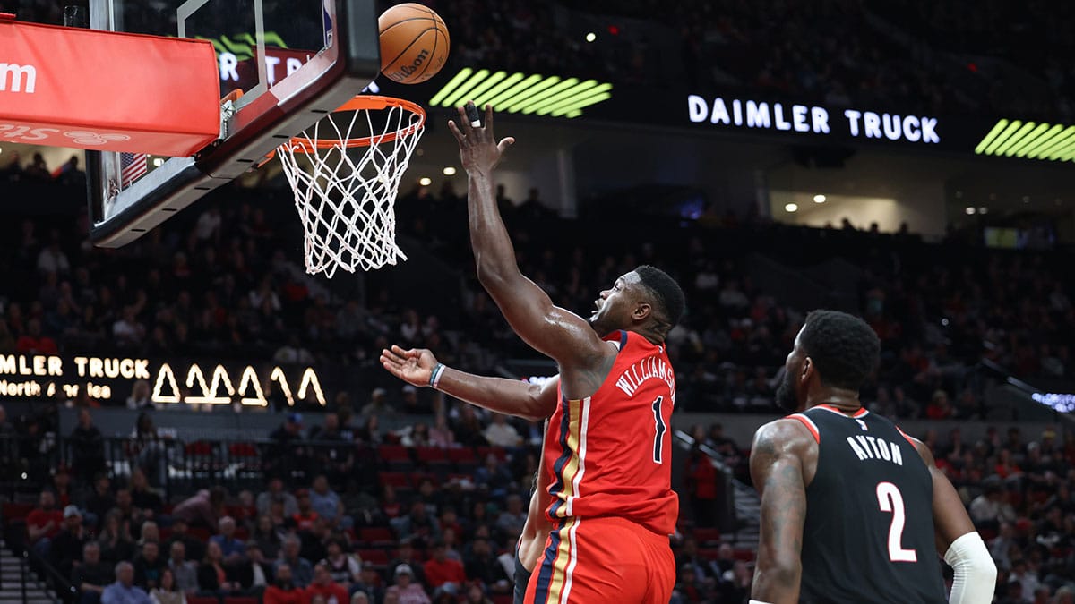 New Orleans Pelicans forward Zion Williamson (1) makes a put back as Portland Trail Blazers center Deandre Ayton (2) watches in the second quarter at Moda Center