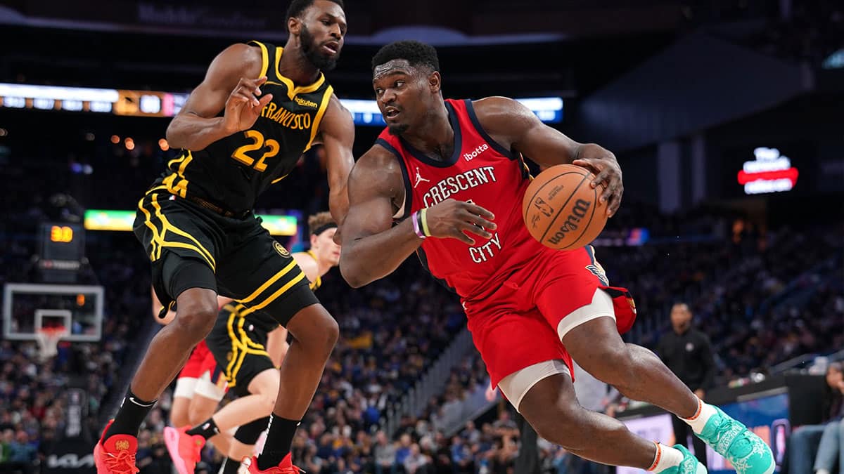 New Orleans Pelicans forward Zion Williamson (1) dribbles past Golden State Warriors forward Andrew Wiggins (22) in the third quarter at the Chase Center. 