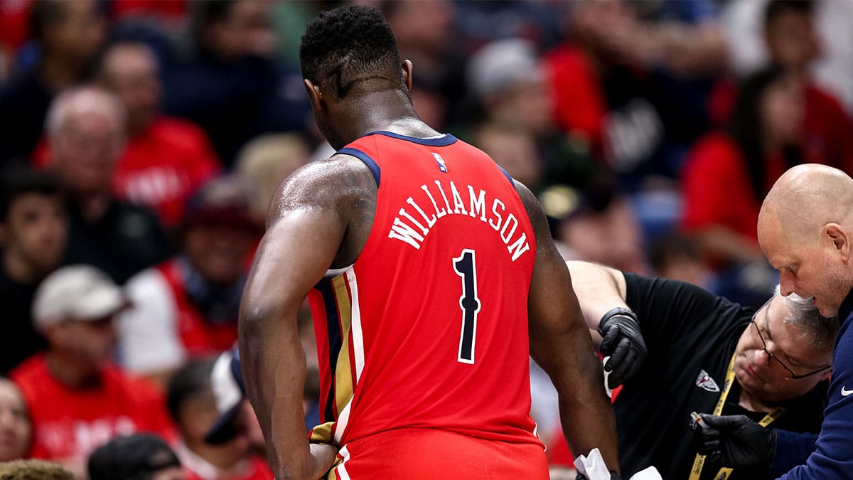 New Orleans Pelicans forward Zion Williamson (1) gets medical attention during the first half against the Los Angeles Lakers in a play-in game of the 2024 NBA playoffs against the New Orleans Pelicans at Smoothie King Center