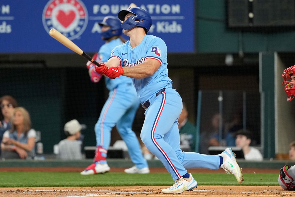 Texas Rangers designated hitter Wyatt Langford (36) hits a two-run inside the park home run against the Cincinnati Reds during the first inning at Globe Life Field. Langford picked up his first major league home run on the play. 