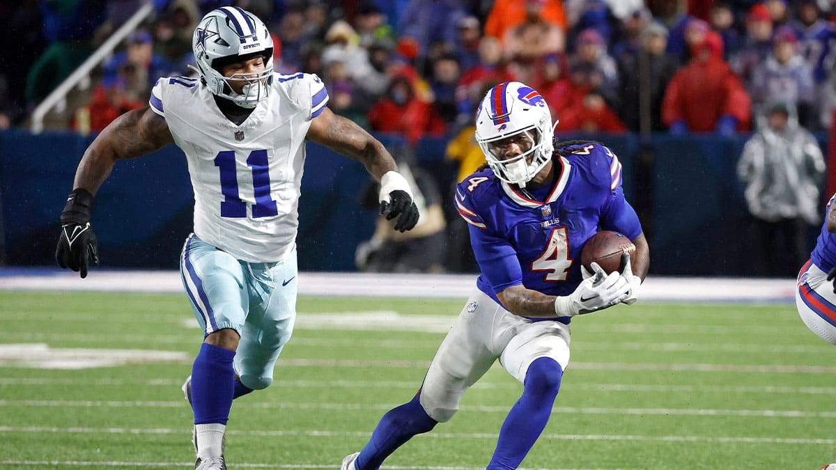 Buffalo Bills running back James Cook (4) gets extra yards as he runs past Dallas Cowboys linebacker Micah Parsons (11). Cook rushed for 179 yards in a 31-10 win.