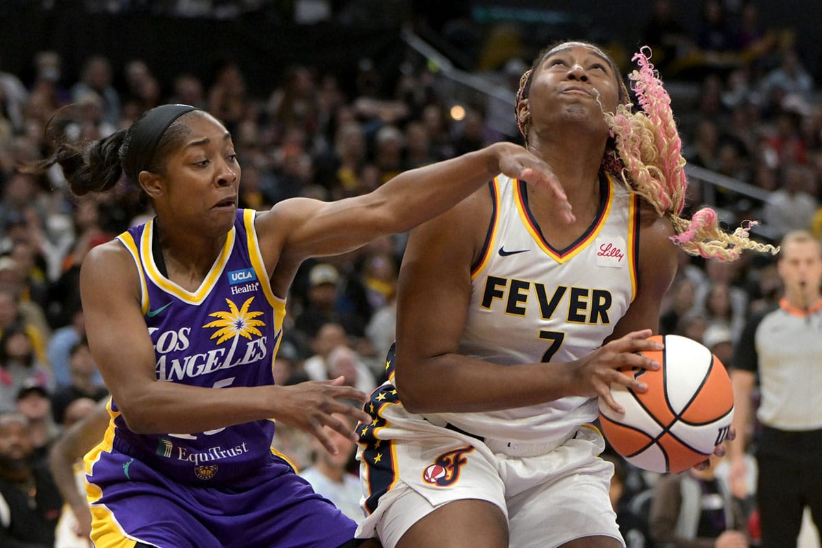 Indiana Fever forward NaLyssa Smith (1) is defended by Los Angeles Sparks guard Aari McDonald (15) as she looks to take a shot in the first half at Crypto.com Arena.