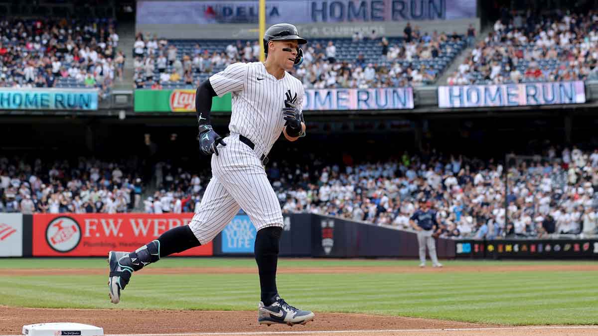New York Yankees center fielder Aaron Judge (99) rounds the bases after hitting a solo home run against the Seattle Mariners during the third inning at Yankee Stadium.