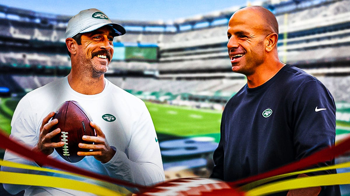 Jets' Aaron Rodgers on the left, smiling at head coach Robert Saleh on the right.