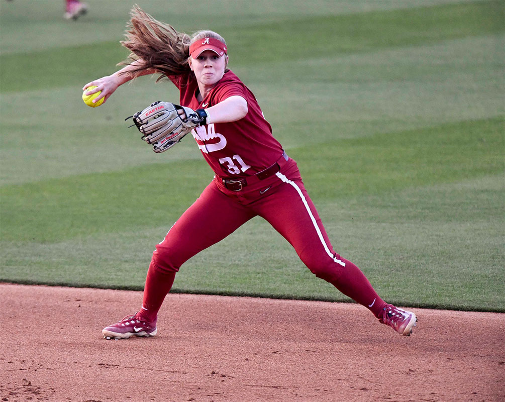 Alabama infielder Kenleigh Cahalan (31) makes a play and throws to first to record an out. Alabama downed Ole Miss 5-1.