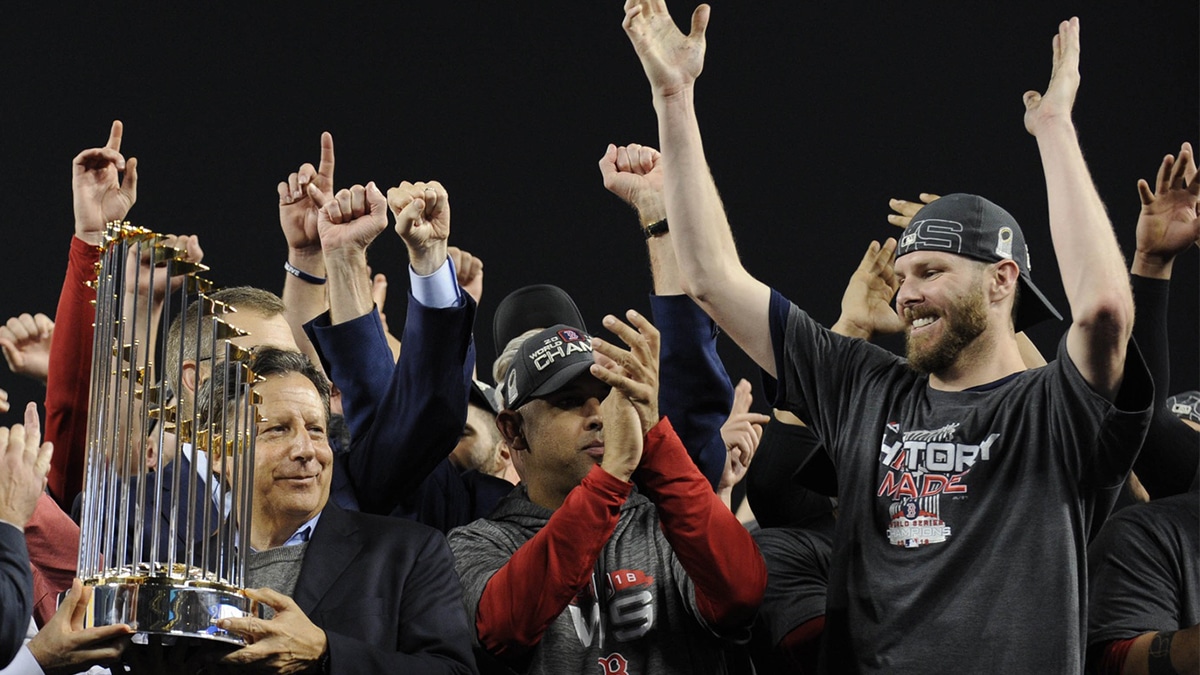 Boston Red Sox owner Tom Werner (left) , manager Alex Cora (middle) and pitcher Chris Sale (right) celebrate with the Commissioner's Trophy after defeating the Los Angeles Dodgers in game five of the 2018 World Series at Dodger Stadium.