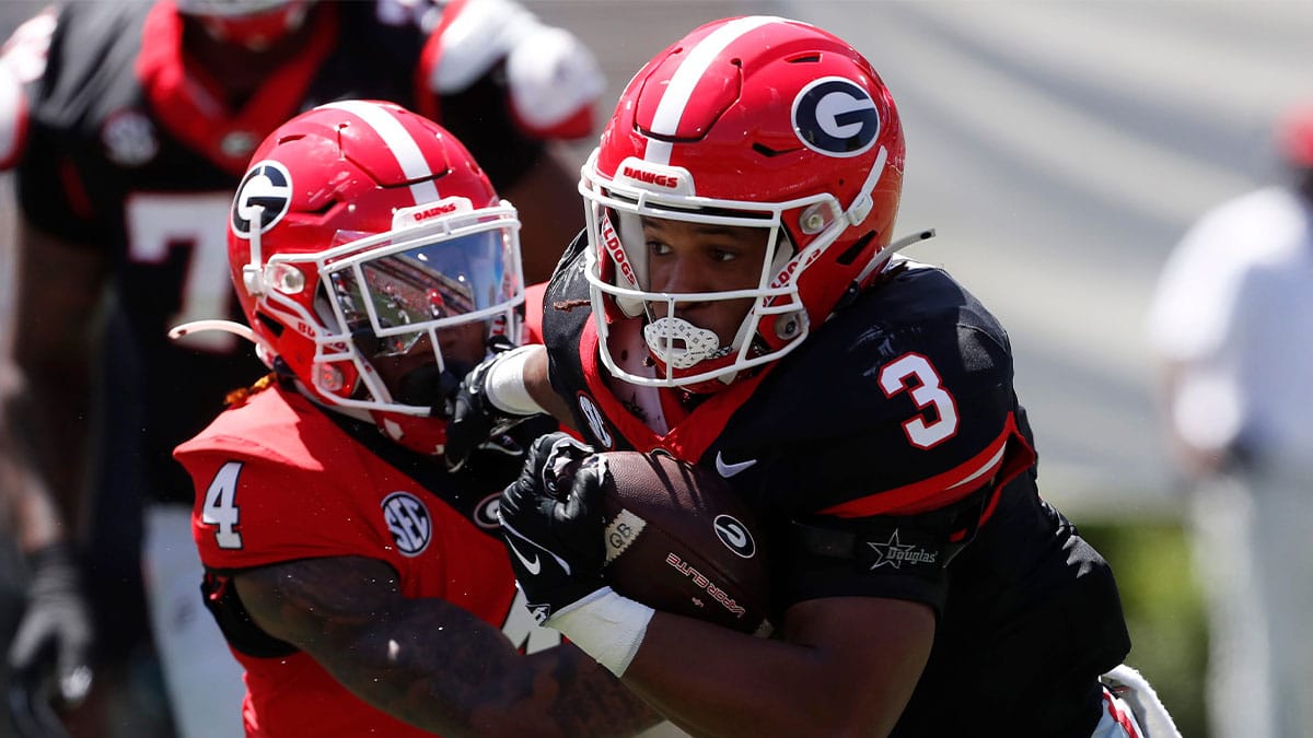 Georgia running back Andrew Paul (3) throws a stiff-arm block on Georgia defensive back JK Bolden (4) during the G-Day spring football game 
