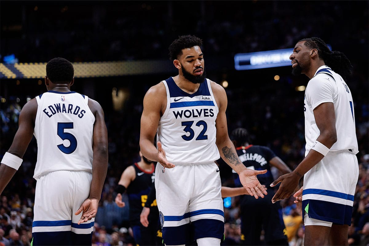Minnesota Timberwolves center Karl-Anthony Towns (32) reacts with center Naz Reid (11) and guard Anthony Edwards (5) in the third quarter during game five of the second round for the 2024 NBA playoffs at Ball Arena.
