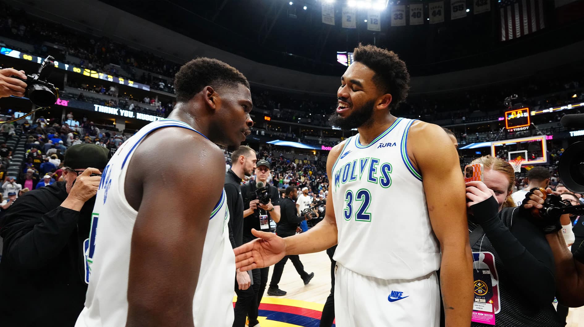 Minnesota Timberwolves guard Anthony Edwards (5) and center Karl-Anthony Towns (32) celebrate defeating the against the Denver Nuggets in game seven of the second round for the 2024 NBA playoffs at Ball Arena.