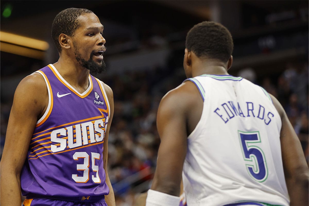 Phoenix Suns forward Kevin Durant (35) shares words with Minnesota Timberwolves guard Anthony Edwards (5) after fouling him in the third quarter at Target Center.
