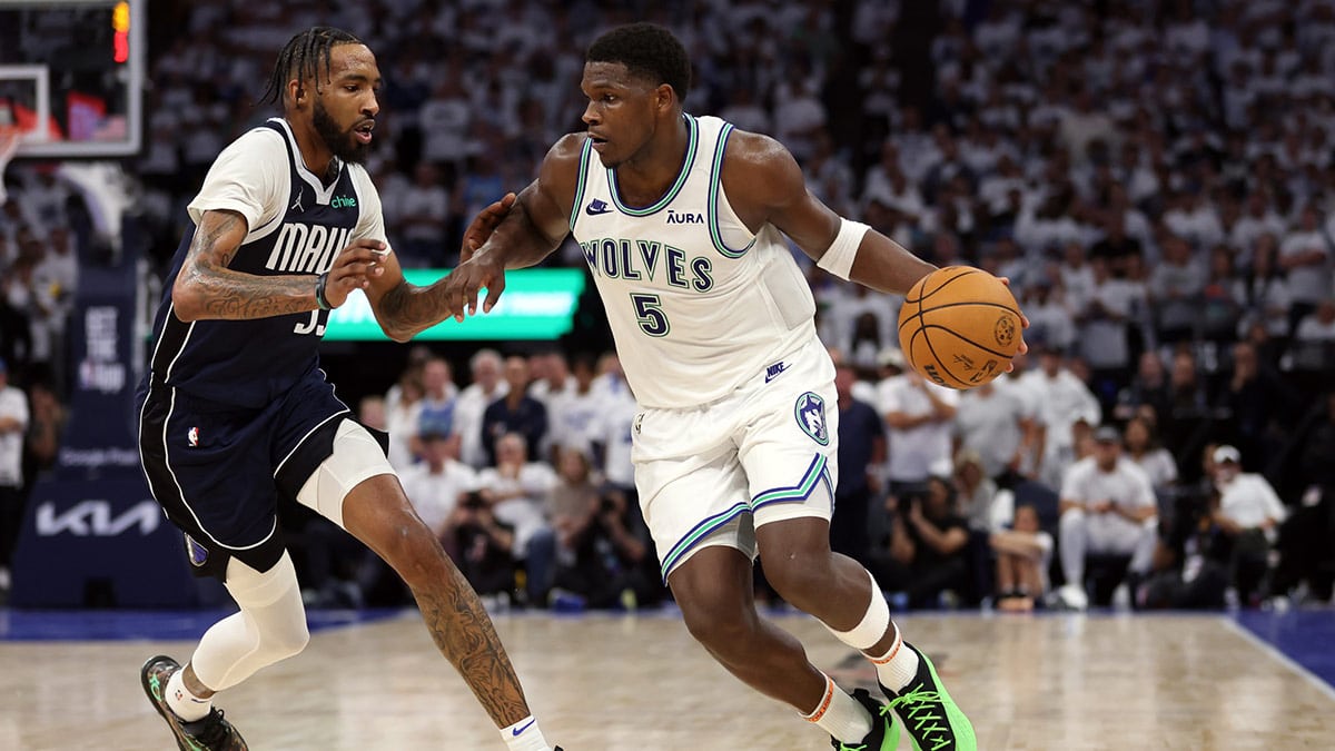 Minnesota Timberwolves guard Anthony Edwards (5) controls the ball against Dallas Mavericks forward Derrick Jones Jr. (55) in the fourth quarter during game one of the western conference finals for the 2024 NBA playoffs at Target Center.
