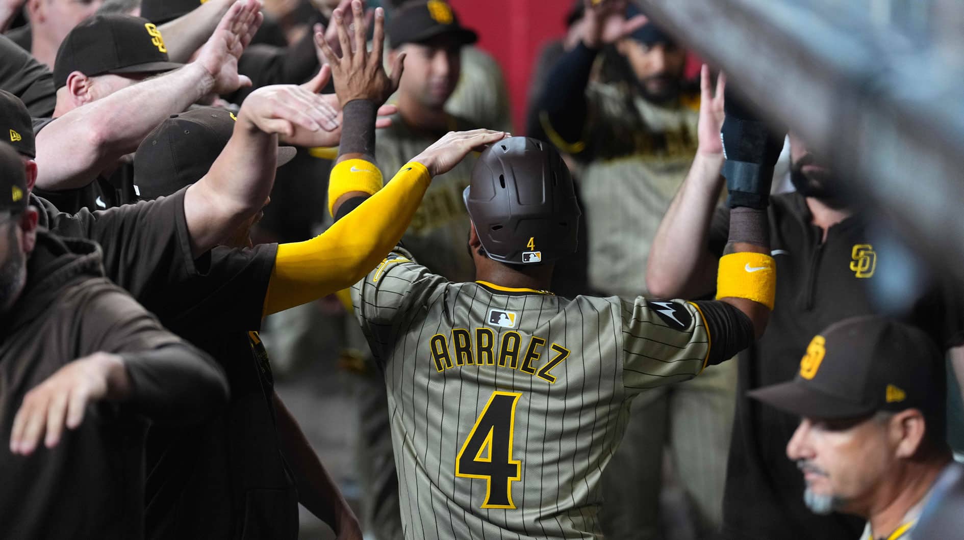 San Diego Padres designated hitter Luis Arraez (4) celebrates with teammates after scoring a run against the Arizona Diamondbacks during the first inning at Chase Field