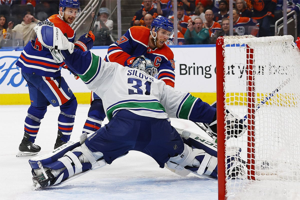 Vancouver Canucks goaltender Arturs Silovs (31) makes a save on on Edmonton Oilers forward Connor McDavid (97) during the third period in game three of the second round of the 2024 Stanley Cup Playoffs at Rogers Place.