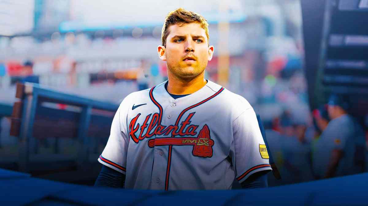 Braves' Austin Riley sitting in an MLB dugout looking concerned.