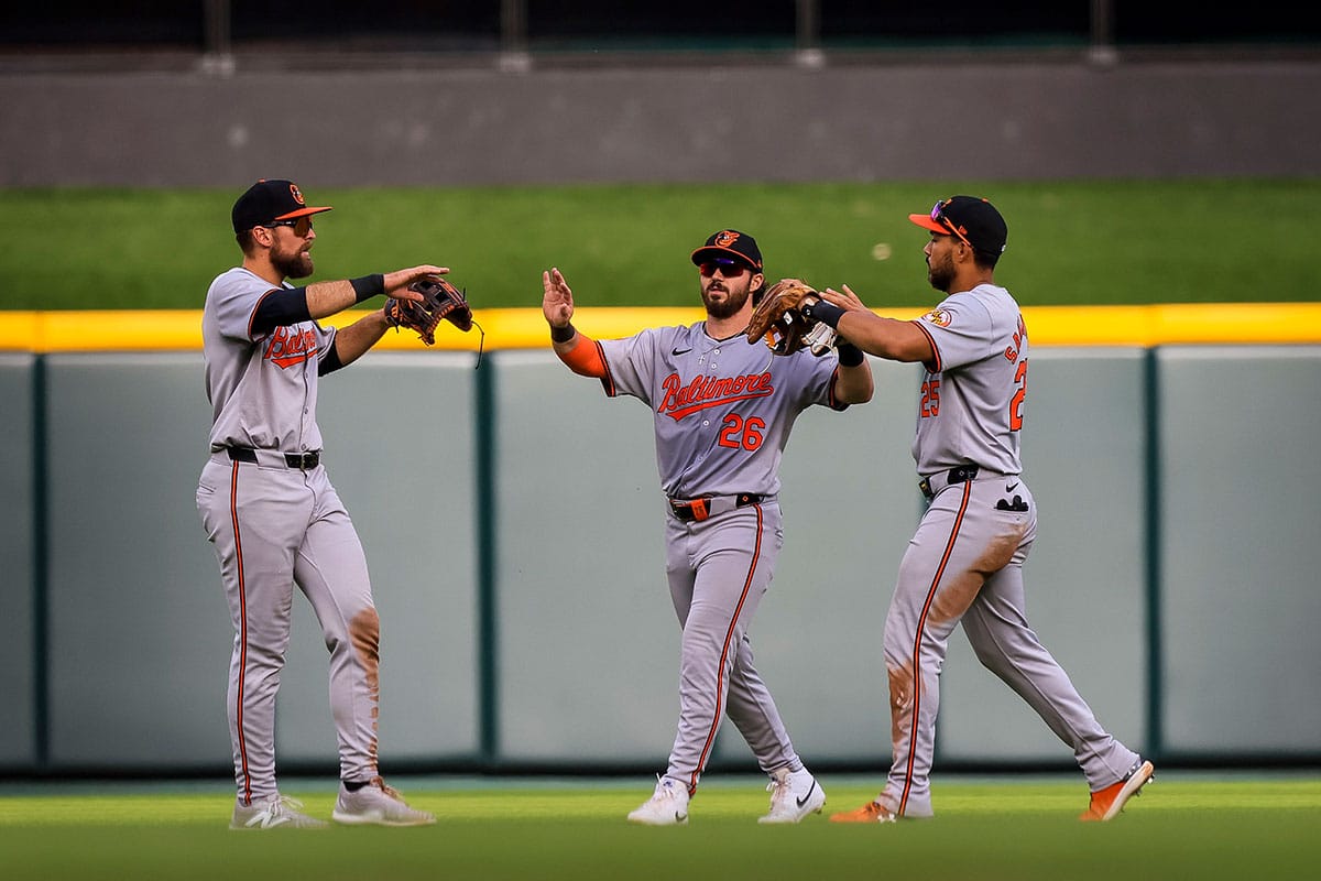 Baltimore Orioles outfielder Colton Cowser (17) high fives outfielder Ryan McKenna (26) and outfielder Anthony Santander (25) after the victory over the Cincinnati Reds at Great American Ball Park. 